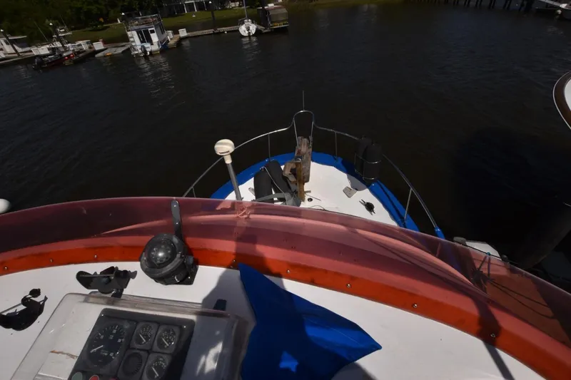 Slide: The Image of 1988 Marine Trader 34 Double Cabin boat deck with navigational instruments and river view. - 15