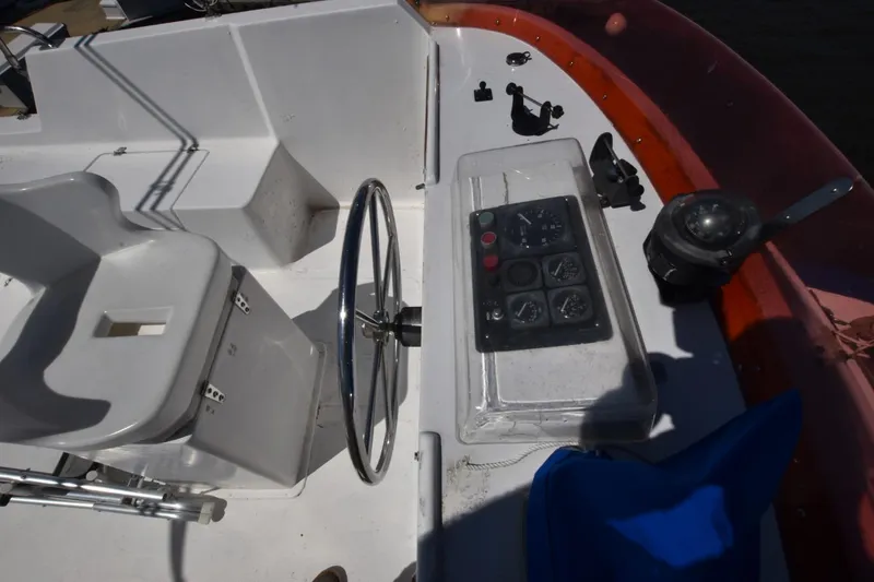 Slide: The Image of 1988 Marine Trader 34 Double Cabin helm with steering wheel and instrument panel. - 16