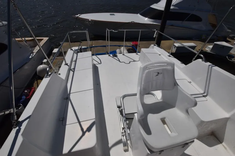 Slide: The Image of 1988 Marine Trader 34 Double Cabin boat deck with seating, docked at marina. - 17