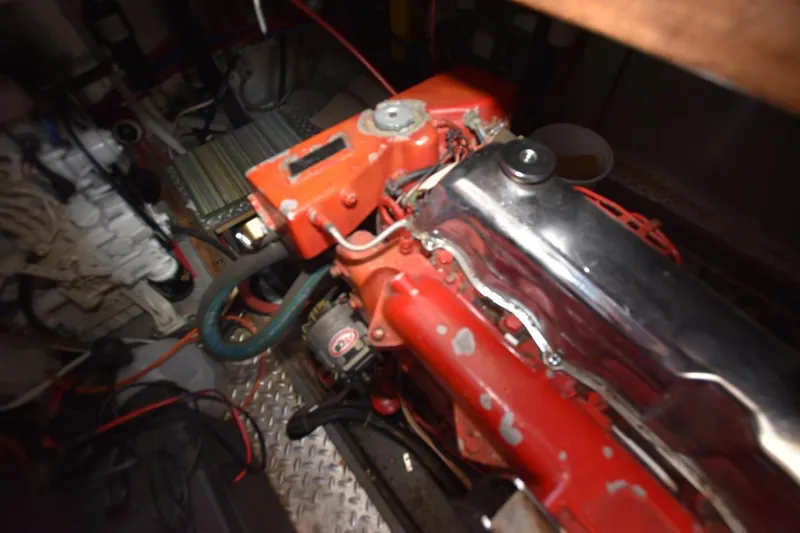 Slide: The Image of Engine room of 1988 Marine Trader 34 Double Cabin with visible red engine components. - 19
