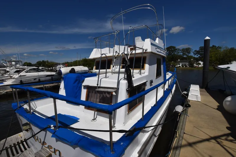 Slide: The Image of 1988 Marine Trader 34 Double Cabin yacht docked at marina under clear blue sky. - 2