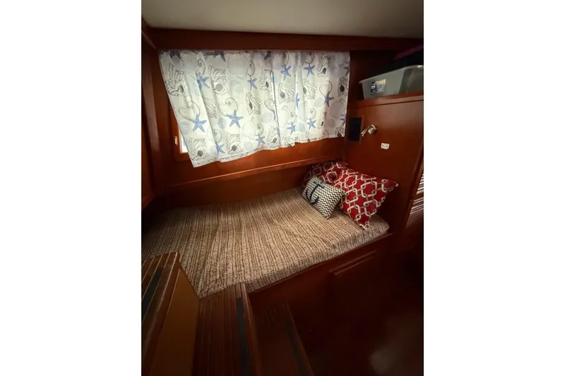 Slide: The Image of Cozy cabin interior of 1988 Marine Trader 34 Double Cabin with decorative pillows and curtains. - 6