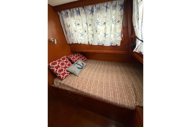 Slide: The Image of Cozy cabin interior of 1988 Marine Trader 34 Double Cabin with decorative pillows and curtains. - 7