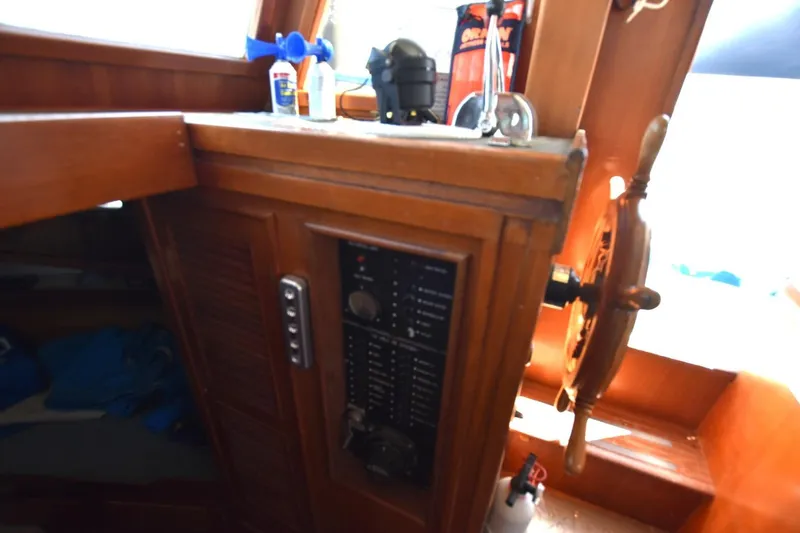 Slide: The Image of 1988 Marine Trader 34 Double Cabin helm with wooden wheel and control panel. - 9