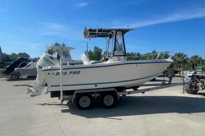 Slide: The Image of Sea Pro 200 Family Fish boat on trailer, featuring Suzuki outboard motor. - 4