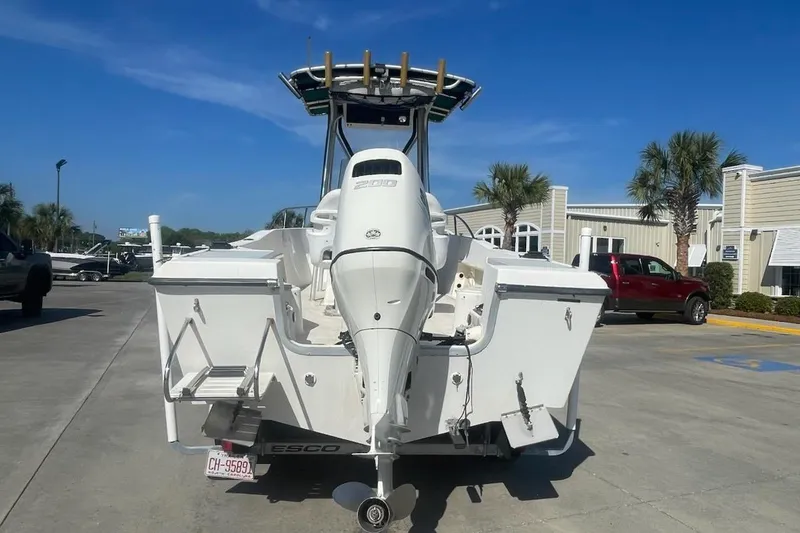 Slide: The Image of Sea Pro 200 Family Fish boat with outboard motor, parked outdoors on a sunny day. - 5