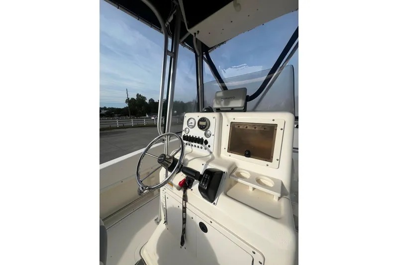 Slide: The Image of Sea Pro 200 Family Fish boat console with steering wheel and navigation equipment. - 6