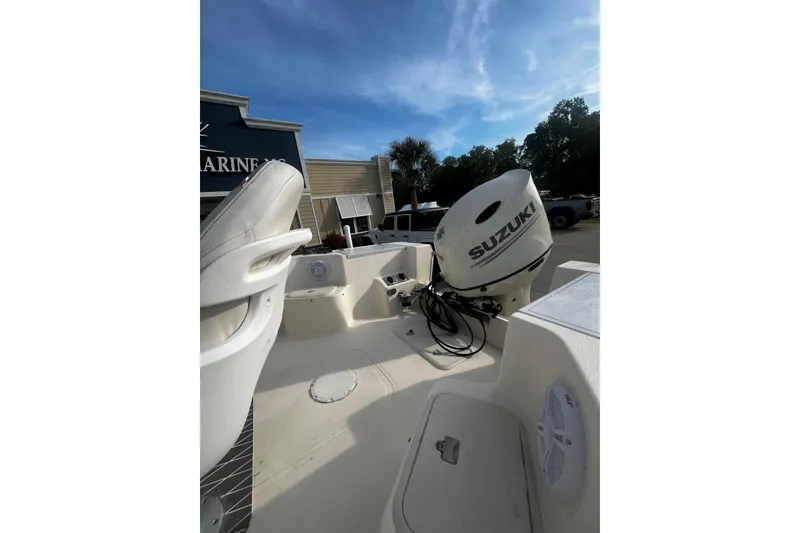 Slide: The Image of Sea Pro 200 Family Fish boat with Suzuki outboard motor in marina setting. - 7