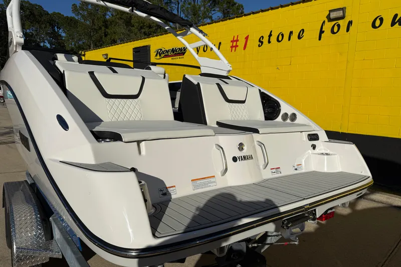 Slide: The Image of 2026 Yamaha Boats 222SD rear view with seating, displayed outdoors. - 10