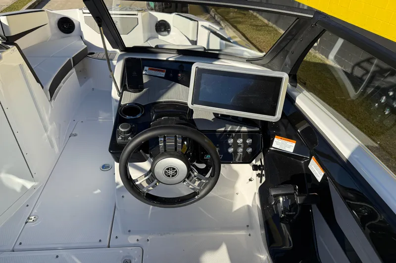 Slide: The Image of Interior view of 2026 Yamaha Boats 222SD, featuring steering wheel and dashboard controls. - 14