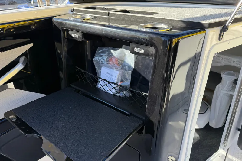 Slide: The Image of Interior view of 2026 Yamaha Boats 222SD, featuring a storage compartment. - 20
