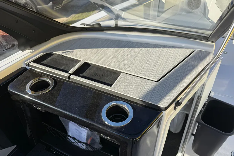 Slide: The Image of Interior view of 2026 Yamaha Boats 222SD, featuring sleek dashboard and cup holders. - 21