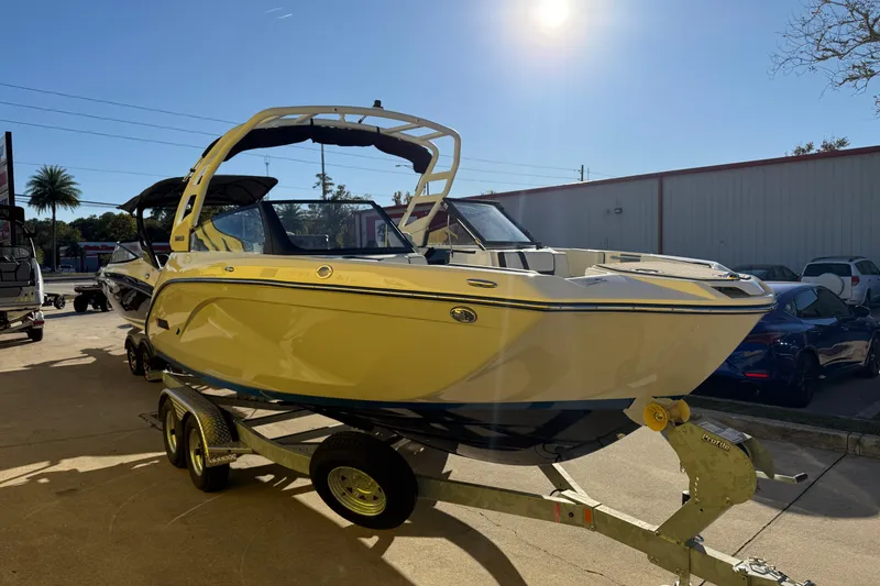 Slide: The Image of 2026 Yamaha Boats 222SD on trailer under bright sunlight, parked outdoors. - 5