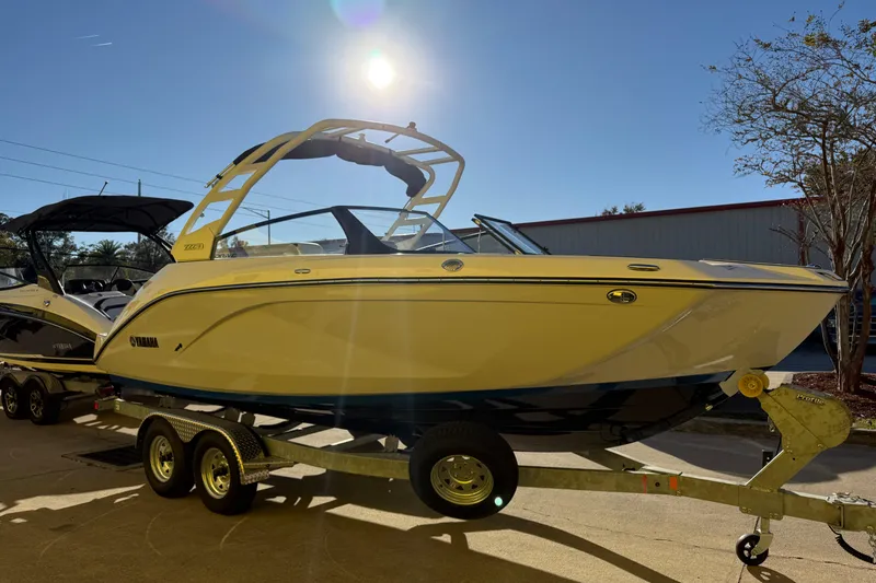 Slide: The Image of 2026 Yamaha Boats 222SD on trailer under bright sun. - 6