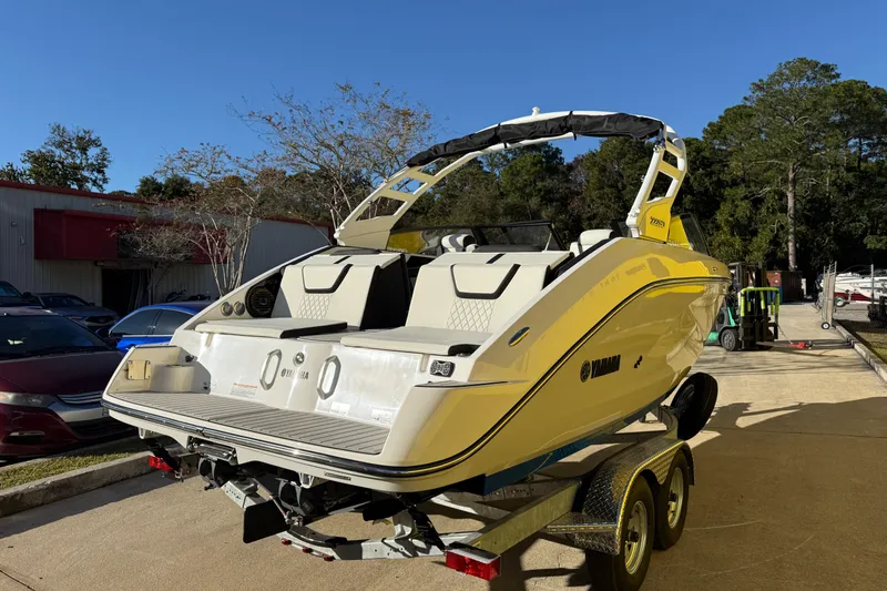 Slide: The Image of 2026 Yamaha Boats 222SD in yellow, parked on a trailer outdoors. - 8
