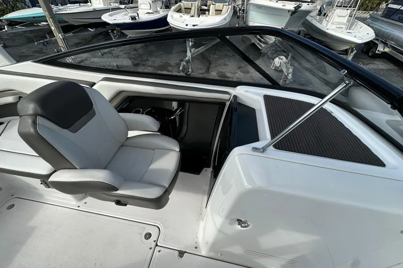 Slide: The Image of 2017 Yamaha Boats 242 Limited S interior with captain's chair and dashboard view. - 16