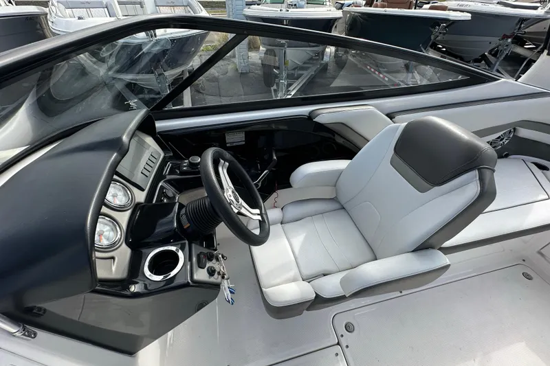 Slide: The Image of 2017 Yamaha Boats 242 Limited S cockpit with steering wheel and comfortable seating. - 18