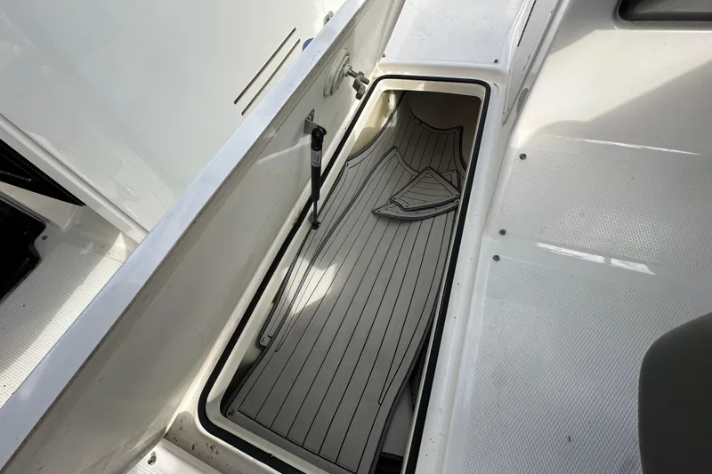 Slide: The Image of Storage compartment in a 2017 Yamaha Boats 242 Limited S, featuring deck mats. - 21