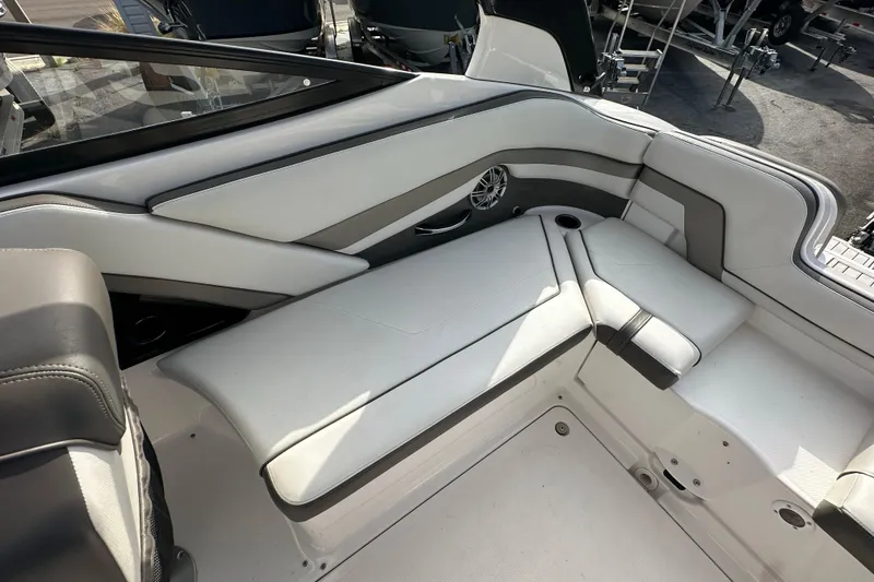 Slide: The Image of 2017 Yamaha Boats 242 Limited S interior seating, featuring sleek white and gray upholstery. - 23
