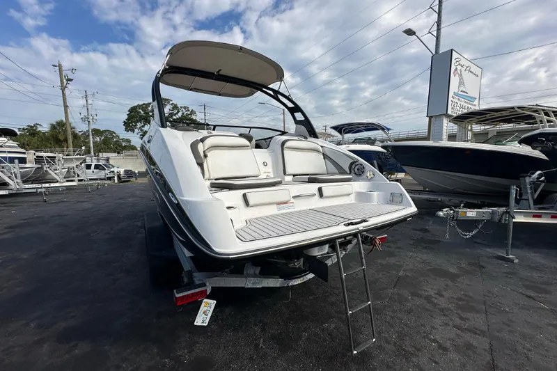 Slide: The Image of 2017 Yamaha Boats 242 Limited S on trailer, showcasing rear deck and seating area. - 3