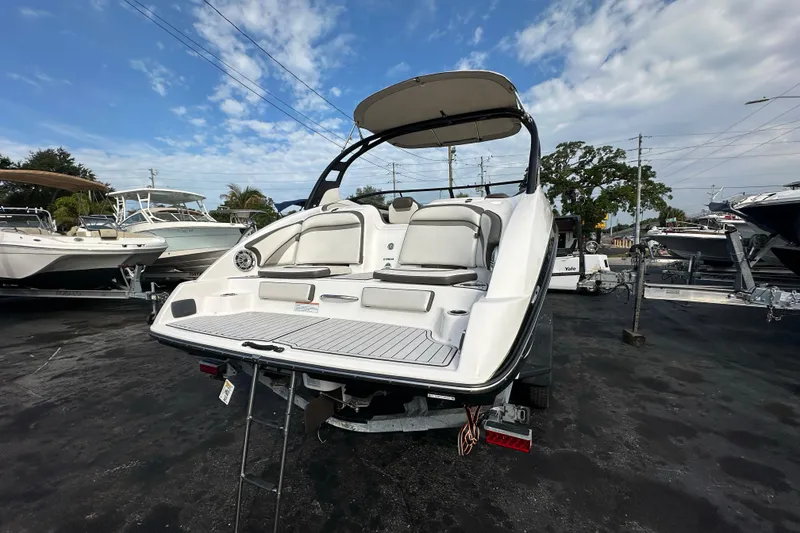 Slide: The Image of 2017 Yamaha Boats 242 Limited S on trailer, showcasing rear seating and swim platform. - 5