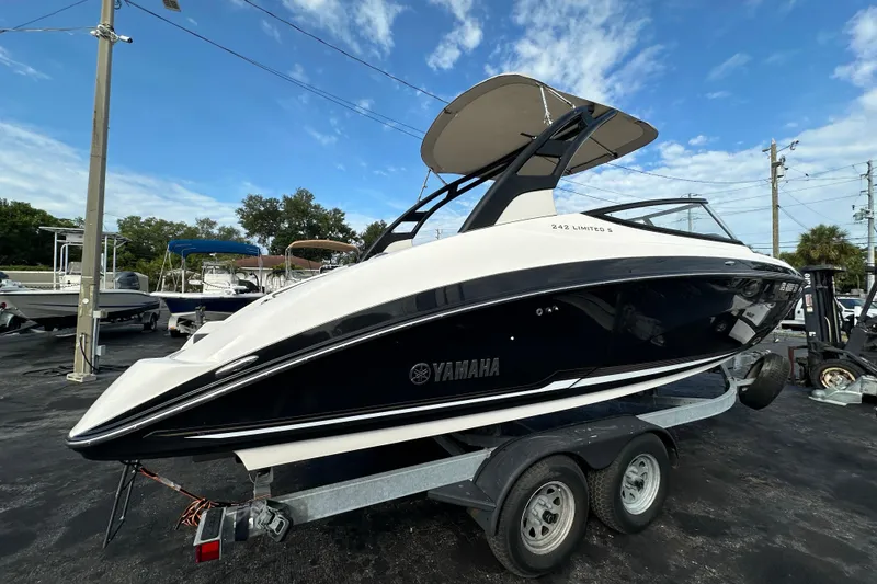 Slide: The Image of 2017 Yamaha Boats 242 Limited S on trailer under blue sky. - 6