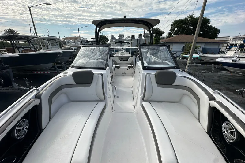 Slide: The Image of 2017 Yamaha Boats 242 Limited S interior with white seating and sleek design. - 8
