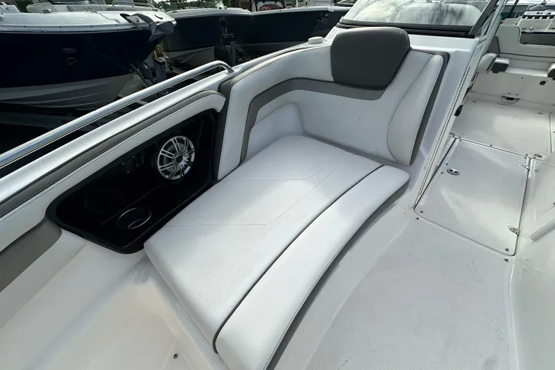 Slide: The Image of 2017 Yamaha Boats 242 Limited S interior with white seating and speaker system. - 9