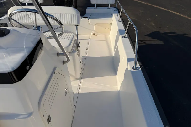 Slide: The Image of 2014 Boston Whaler 190 Montauk boat interior with steering wheel and seating. - 11