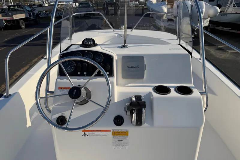 Slide: The Image of 2014 Boston Whaler 190 Montauk boat console with steering wheel and Garmin device. - 13