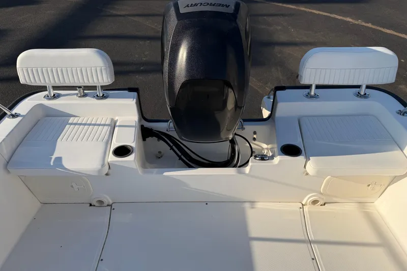 Slide: The Image of 2014 Boston Whaler 190 Montauk boat interior with Mercury engine and seating. - 14