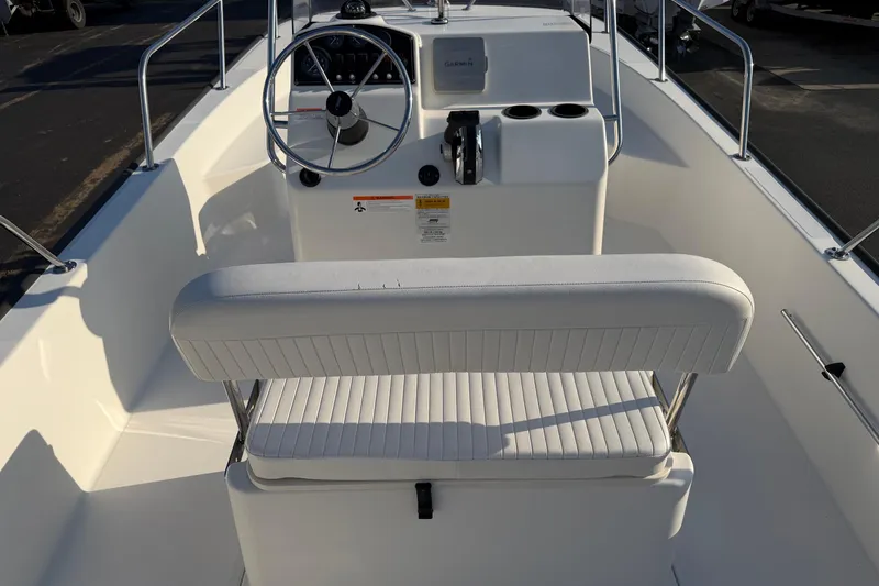 Slide: The Image of 2014 Boston Whaler 190 Montauk boat interior with steering wheel and seating. - 15