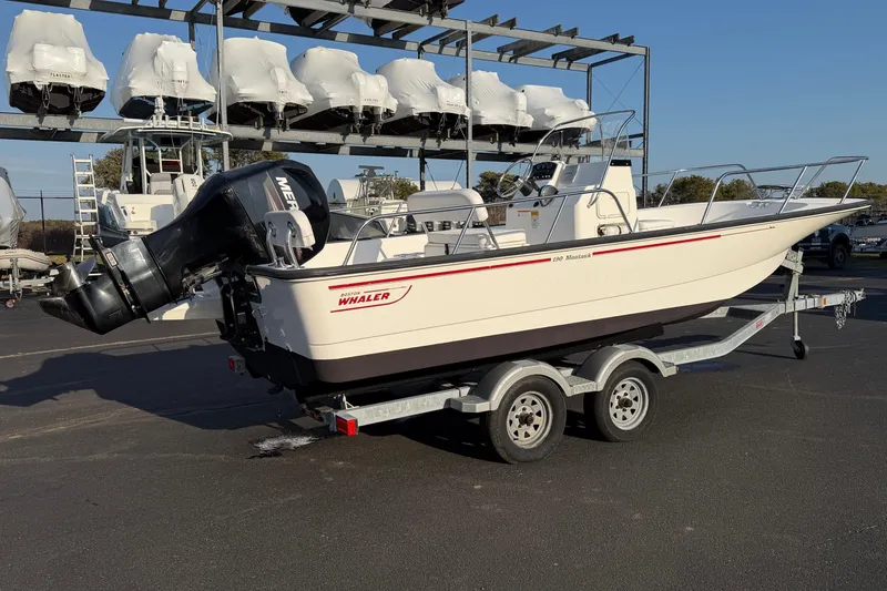 Slide: The Image of 2014 Boston Whaler 190 Montauk boat on trailer, outdoor storage area. - 4