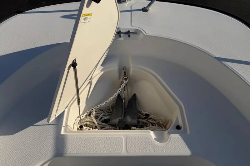 Slide: The Image of Open anchor storage on 2014 Boston Whaler 190 Montauk boat, showing anchor and rope. - 6