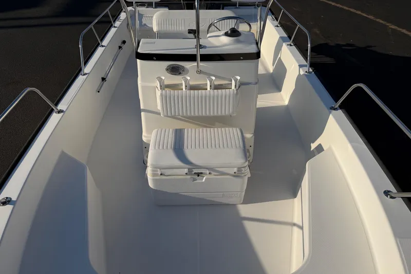 Slide: The Image of 2014 Boston Whaler 190 Montauk boat interior with seating and steering console. - 8