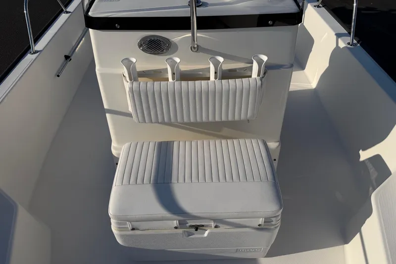 Slide: The Image of 2014 Boston Whaler 190 Montauk interior with cushioned seating and rod holders. - 9
