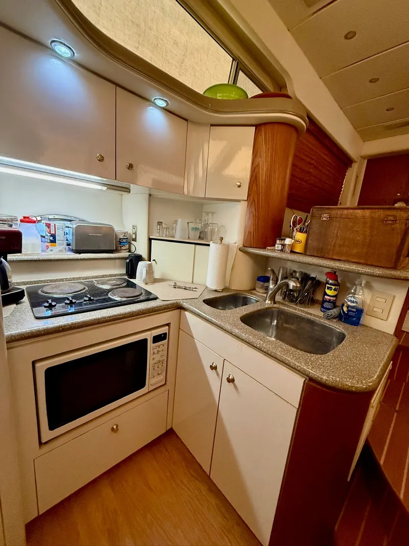 Slide: The Image of Kitchen area of the 1999 Maxum 4100 SCA yacht. - 10