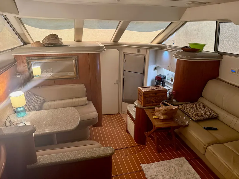 Slide: The Image of Interior of a 1999 Maxum 4100 SCA yacht with cozy seating area. - 13