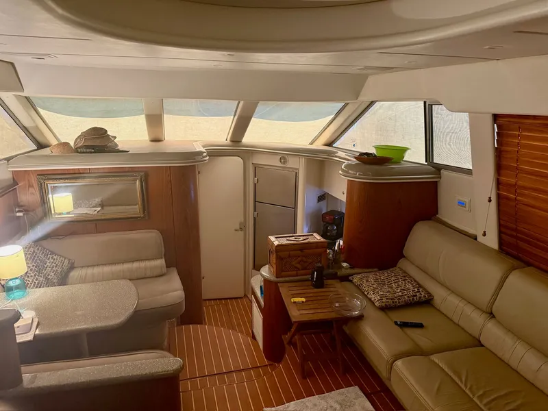 Slide: The Image of Interior of a 1999 Maxum 4100 SCA yacht with cozy seating area. - 14