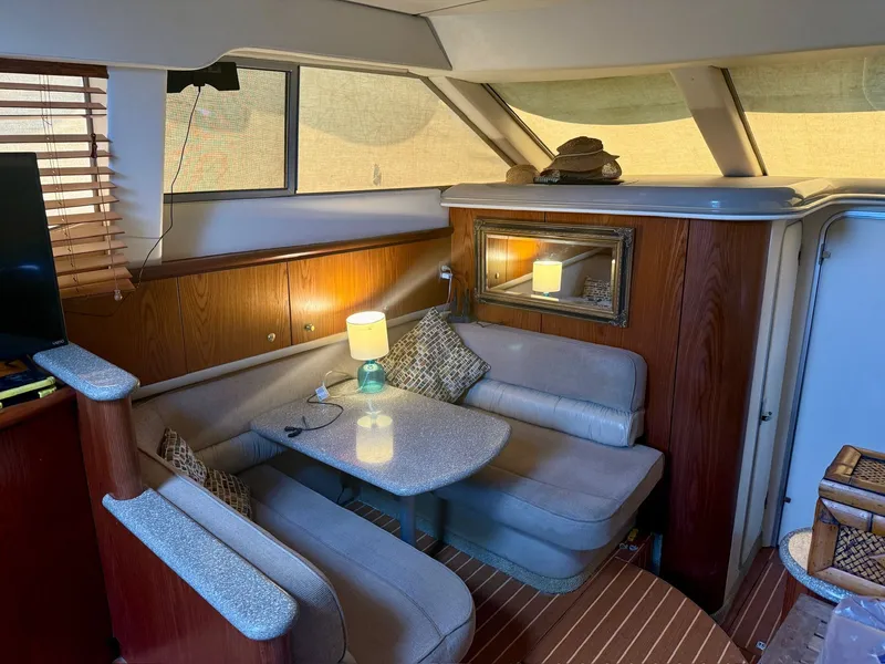 Slide: The Image of Interior of a 1999 Maxum 4100 SCA yacht with cozy seating area. - 15