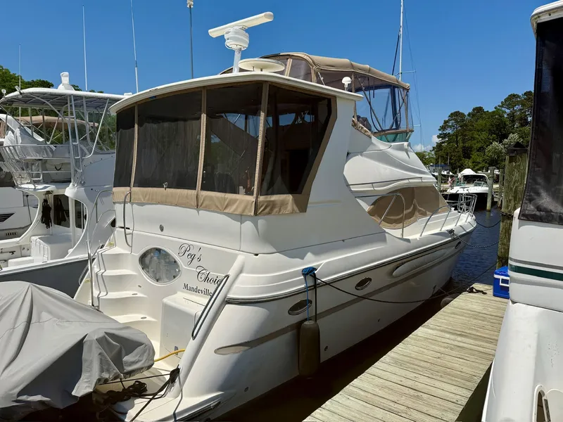 Slide: The Image of 1999 Maxum 4100 SCA yacht docked at marina. - 18