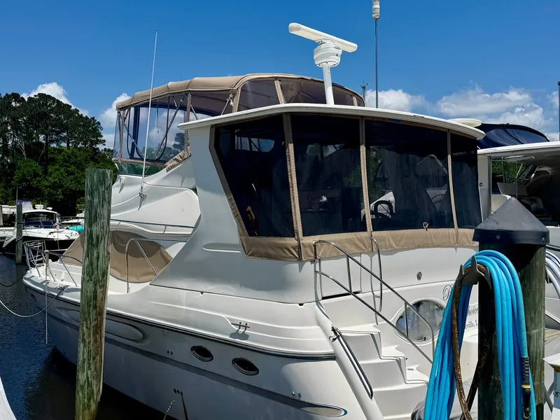 Slide: The Image of 1999 Maxum 4100 SCA yacht docked in sunny marina. - 20