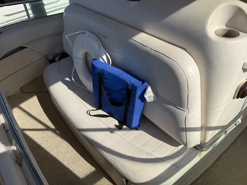 Slide: The Image of Interior of a 1999 Maxum 4100 SCA boat with seating and life jacket. - 22