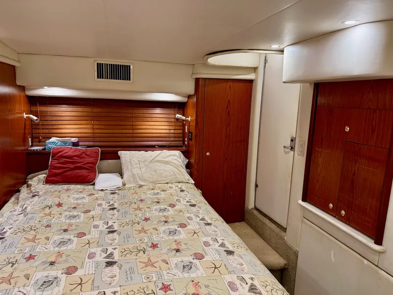 Slide: The Image of Interior of 1999 Maxum 4100 SCA yacht featuring cozy bedroom. - 4