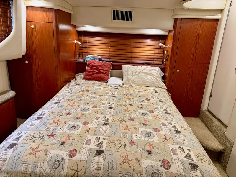 Slide: The Image of 1999 Maxum 4100 SCA yacht interior featuring a cozy bedroom. - 6