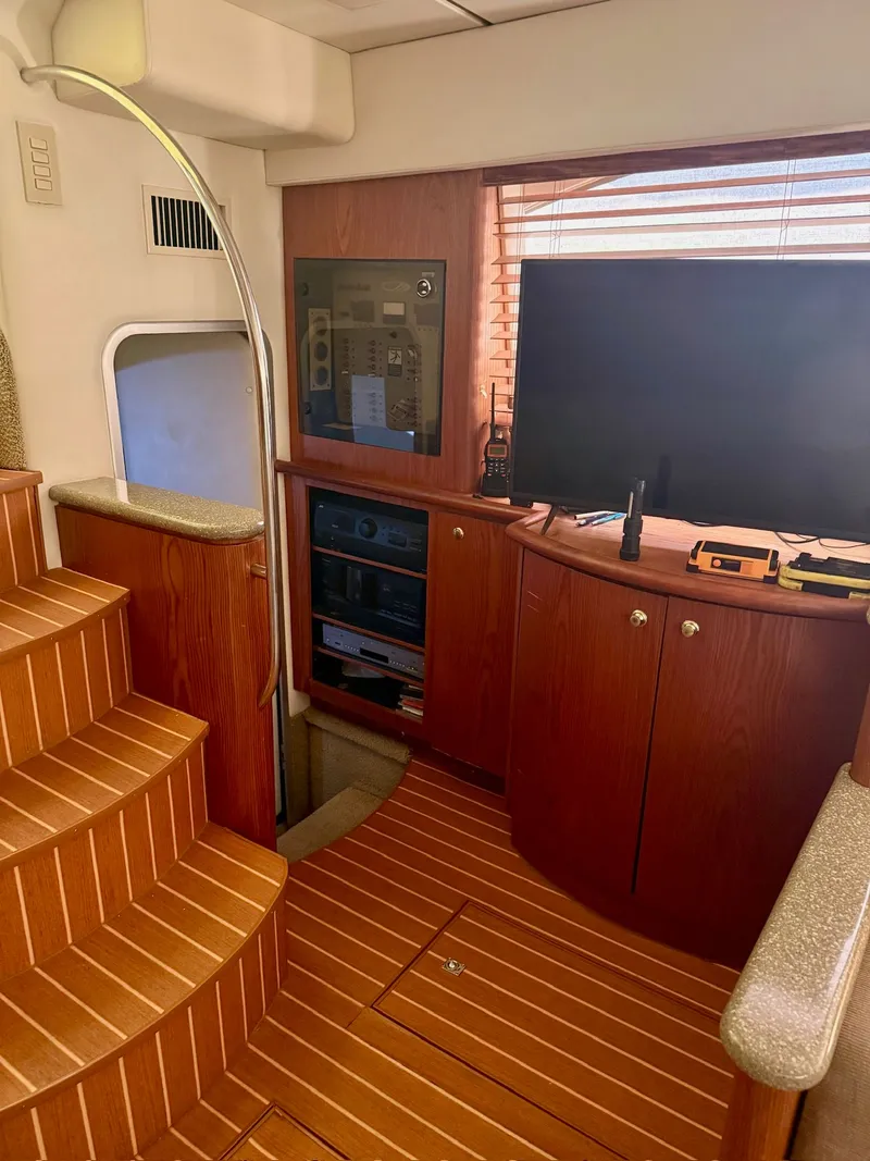 Slide: The Image of Interior of a 1999 Maxum 4100 SCA yacht with wood paneling and entertainment system. - 8