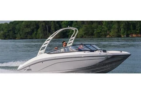 Slide: The Image of 2026 Yamaha Boats 195S cruising on a lake with lush green trees in the background. - 11