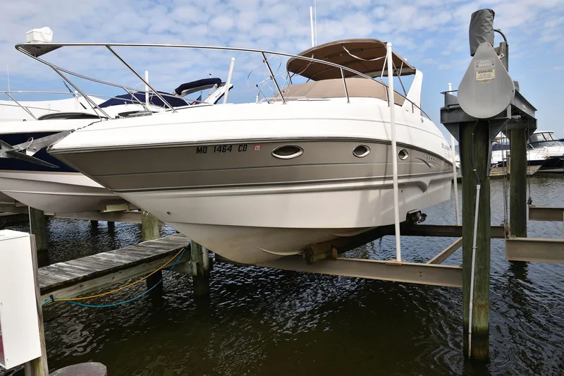 The Image of 2009 Larson Cabrio 310 boat docked on a lift. - 0