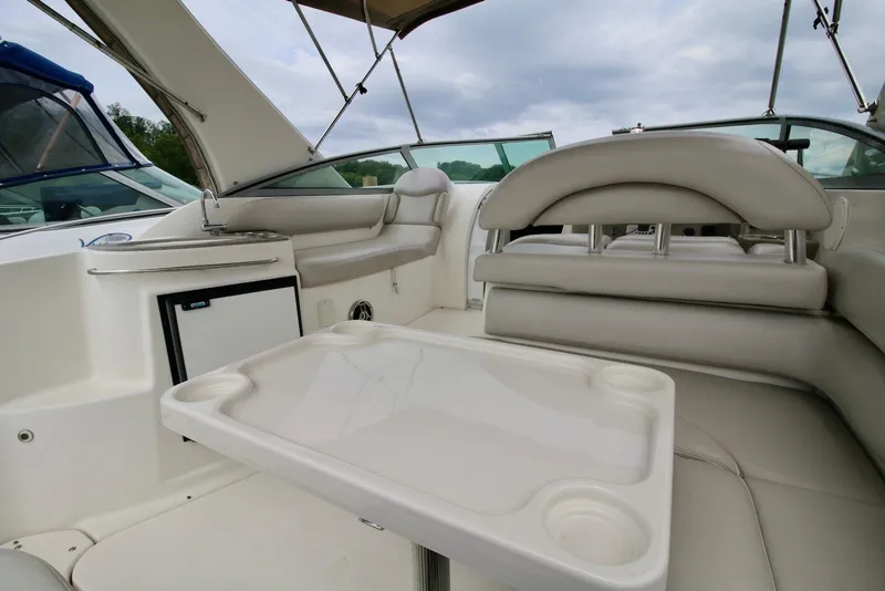 Slide: The Image of Interior of a 2009 Larson Cabrio 310 boat with seating and table. - 13