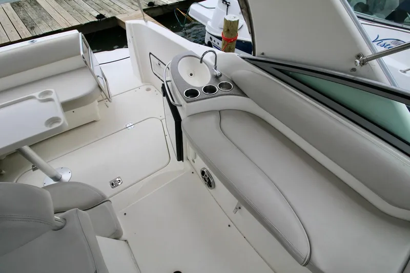 Slide: The Image of 2009 Larson Cabrio 310 boat interior with seating, sink, and cup holders. - 14